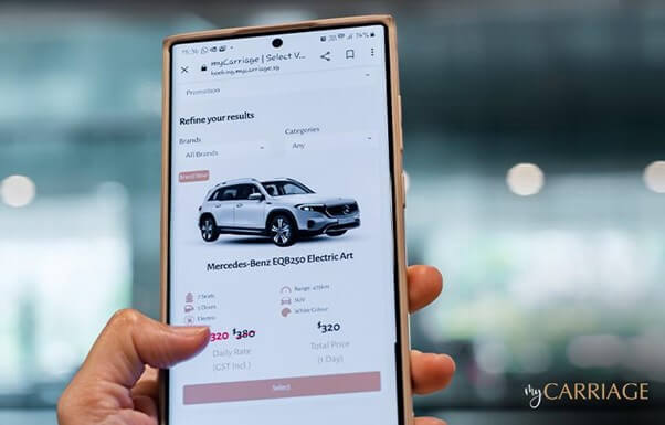 Image of a person browsing a car rental page on their phone